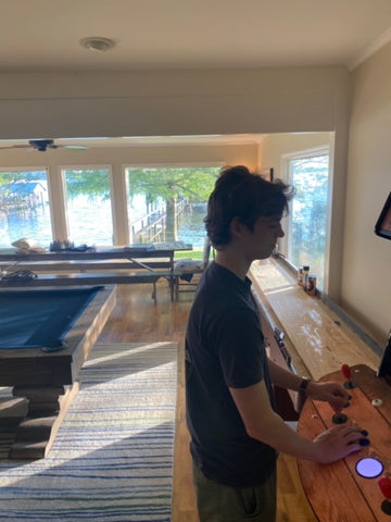 Person Playing With Arcade machine